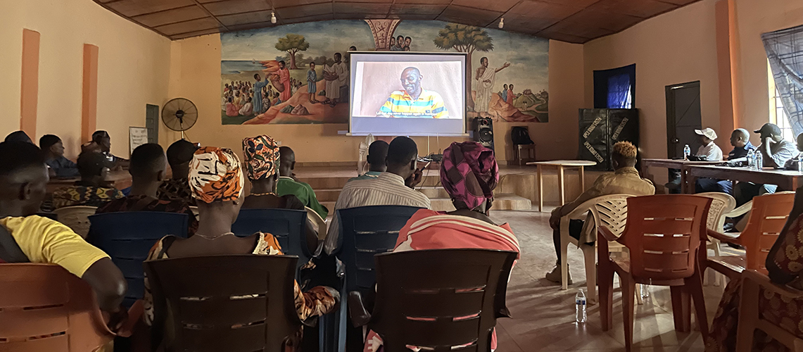 A preview screening of the film Tarma: Communities on the Frontlines of Epidemic Response at a church hall in Kambia, Sierra Leone