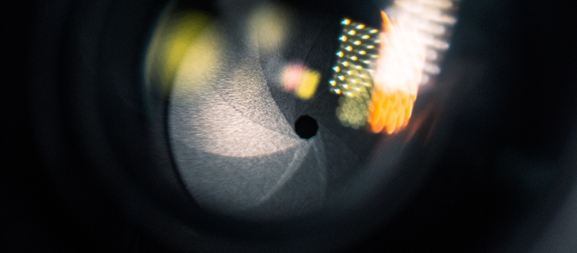 A close up view of a camera lens (Photo by Colin Lloyd on Unsplash)
