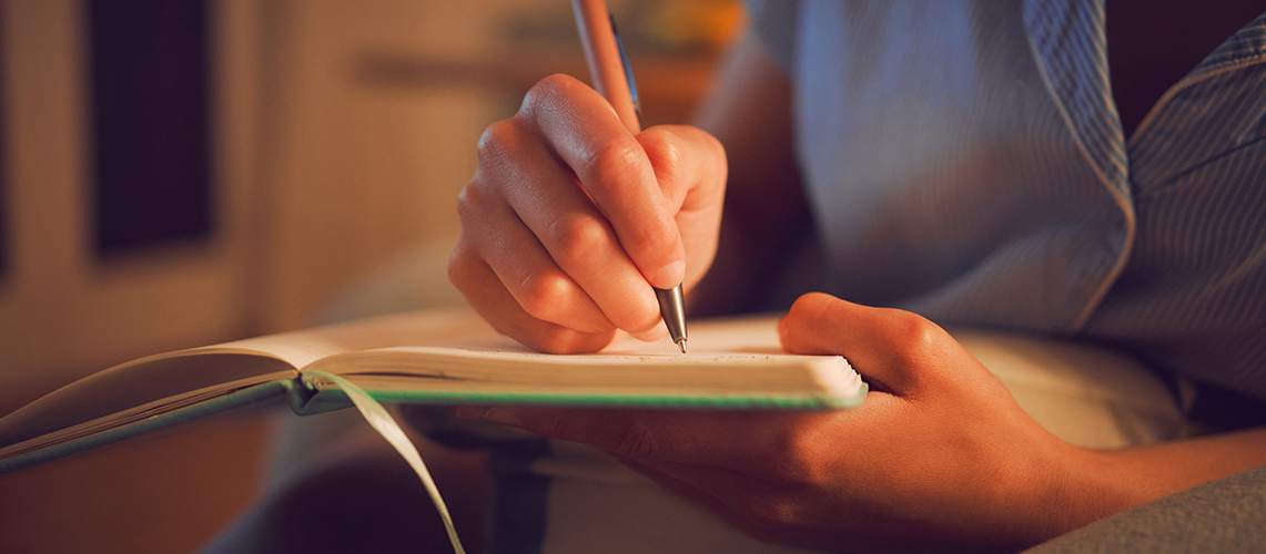 A person writing in a diary