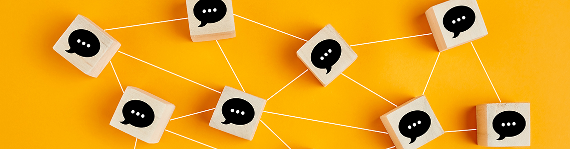 A network of cubes with speech bubbles on connected by lines A network of cubes with speech bubbles on connected by lines