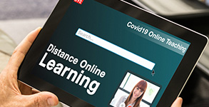 A tablet showing the words distance online learning A tablet showing the words distance online learning