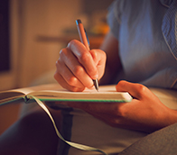 A person writing in a diary