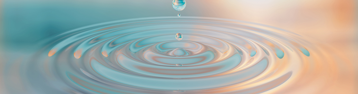 A droplet creating a ripple in a pool of water